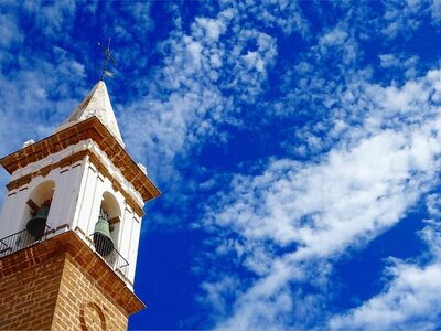 Angustias church bell in Ayamonte with sky background, Spain