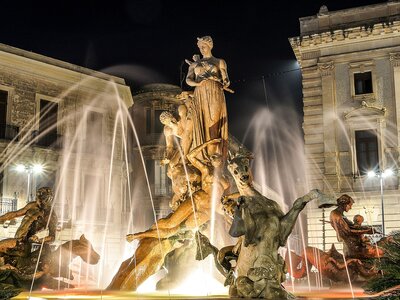 Diana fountain Artemis fountain at night time, archimedes square, Ortygia island, Syracuse, Sicily, Italy