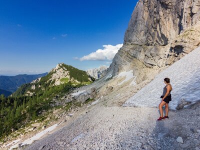 Lady admiring views of Slemenova mountain on hiking trail, Slovenia