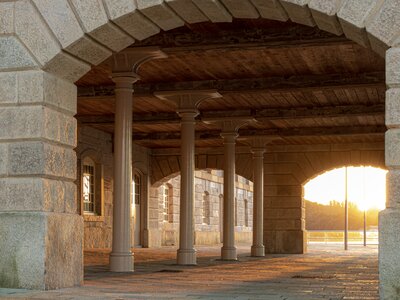 Sunset of the Royal William Yard appearing through brick archway and pillar underpass