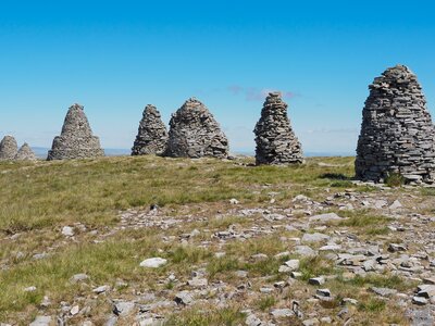 Stone cairns of Nine Standards Rigg under blue sky near summit of Hartley Fell, Eden Valley